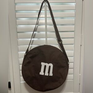 M&M brown circular bag. Good shape. Some wear as seen in pictures